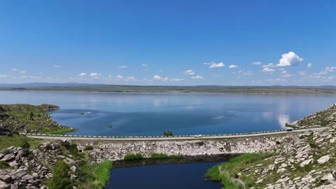 Aerial view of Bukhtarma Reservoir split by road with cars, Eastern Kazakhst Stock Footage 317510727