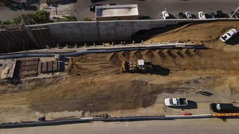 Aerial view of bulldozer at work during construction on California freeway. Stock Footage 164084144