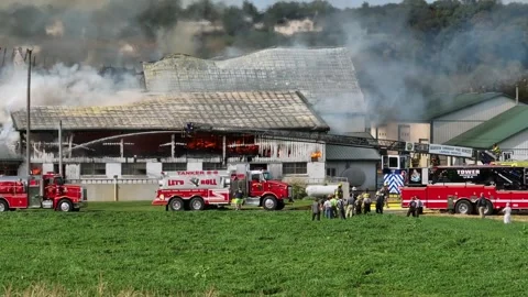 Aerial view of burning barn scene in american countryside. Sunny day in Stock Footage 320219133