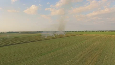 Aerial view of a burning field, outside a city, the air is filled with smoke Stock Footage 78044096