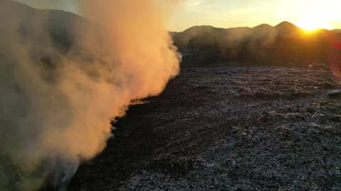 Aerial view of burning garbage dump pollution at sunset Vídeo Stock 346243555