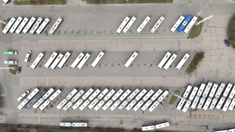 Aerial view of a bus fleet parked in a lot, showcasing a continuous arrangement Stock-Footage 335876563