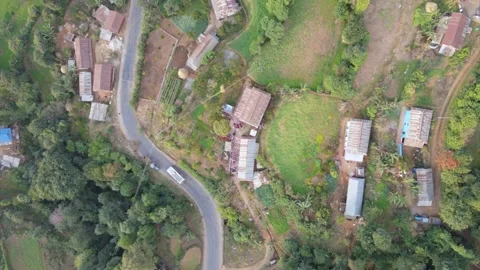 Aerial view of A bus running on The mountain road road in the village Stock Footage 155366916