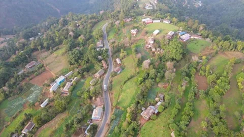 Aerial view of A bus running on The mountain road road in the village Stock Footage 155366926