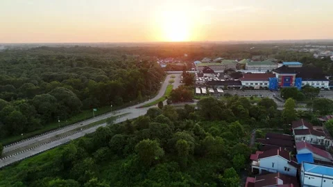 Aerial View of Bus Terminal Complex and Forest at Dusk Stock-Footage 347526412