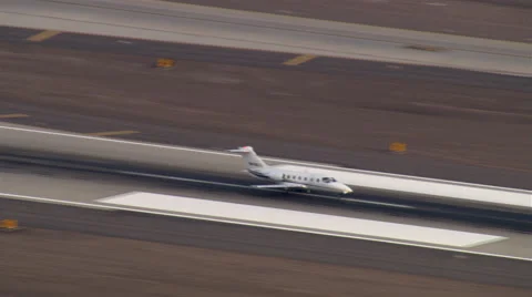 Aerial view of business jet ascending from runway Stock Footage 59477726