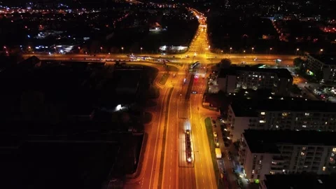 Aerial view of bustling city intersection at night, illuminated roads Stock Footage 320125993