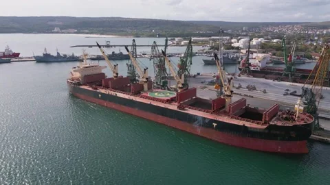 Aerial view of a bustling seaport, where a massive cargo ship, a bulk carrier Stock Footage 252188094