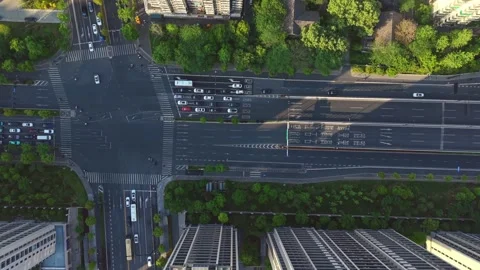 Aerial view of a bustling urban intersection with cars moving in all directions. Stock Footage 307315090