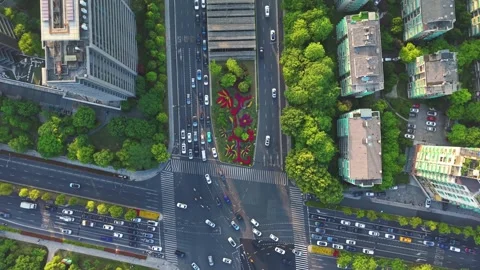 Aerial view of a bustling urban intersection filled with cars and pedestrians. Video stock 307315239