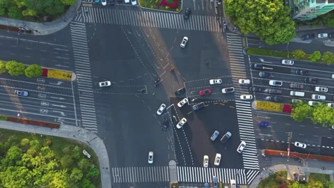Aerial view of a bustling urban intersection filled with cars and pedestrians. Stock-Footage 309085815