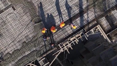 Aerial View: A busy construction site with workers and engineers pouring Stock Footage 296073053