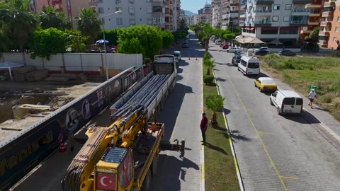 Aerial View: A busy construction site with engineers overseeing metalwork and Stock Footage 296094598