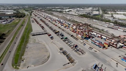 Aerial view of busy container shipping yard with trains and trucks moving c.. Stock Footage 337282405