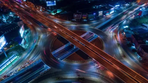 Aerial view of a busy highway interchange and roundabout at night Stock Footage 346076534