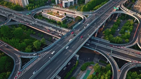Aerial view of a busy highway junction in an urban setting during early morning Stock Footage 311528211