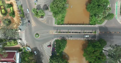 Aerial view of a busy intersection and muddy river in Siem Rep, Cambodia Stock Footage 335417865