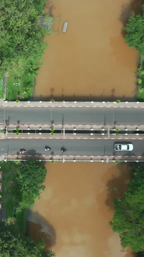 Aerial view of a busy intersection and muddy river in Siem Rep, Cambodia Stock Footage 335421438