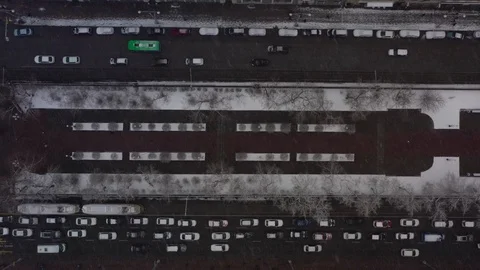 Aerial view of a busy intersection with dense traffic during heavy snowfall. Stock Footage 109333682