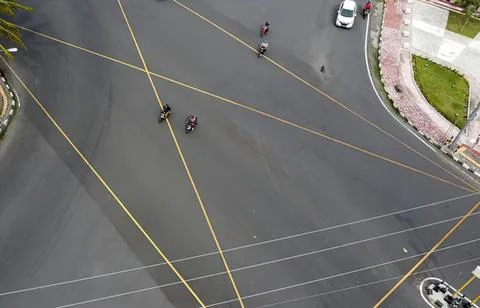 Aerial view of a busy intersection with motorcycles and cars Stock Photos