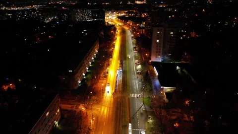 Aerial view of busy intersection at night, showcasing dynamic traffic flow with Stock Footage 347791936
