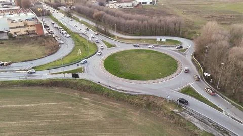 Aerial view of a busy roundabout intersection with cars navigating the traf.. Stock Photos