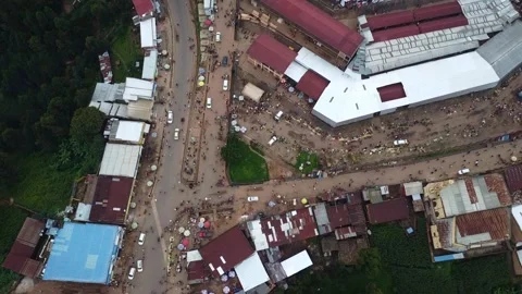 Aerial view of a busy street intersection in a town with buildings and vehicles Stock Footage 317837780