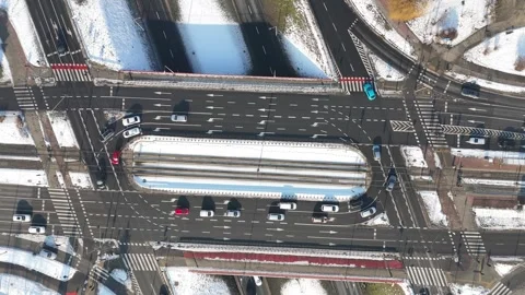 Aerial view of busy urban intersection with multiple lanes, vehicles in motion Stock Footage 328295046