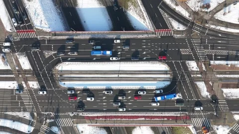 Aerial view of busy urban intersection with multiple lanes, vehicles in motion Stock Footage 328295188