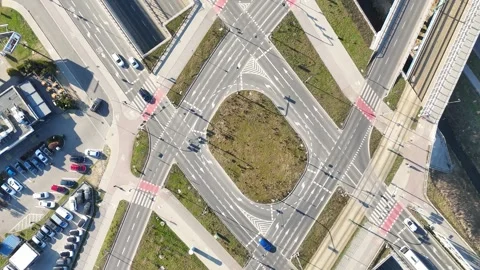 Aerial view of busy urban intersection with multiple roads, crosswalks, and Stock Footage 335876742