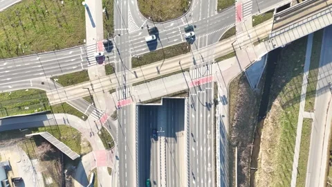 Aerial view of busy urban intersection with multiple roads, crosswalks, and Stock Footage 335876855