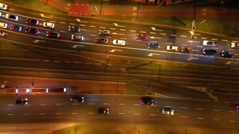 Aerial view of busy urban intersection at night, showcasing flowing traffic with Video stock 335886423