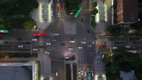 Aerial view of busy urban intersection with vehicles in motion at night Video stock 339124452