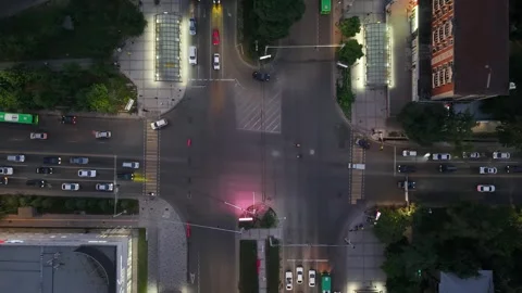 Aerial view of busy urban intersection with vehicles in motion at night Video stock 339124460