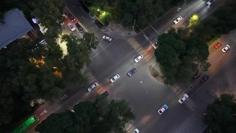 Aerial view of busy urban intersection with cars and streetlights at night Video stock 339124623