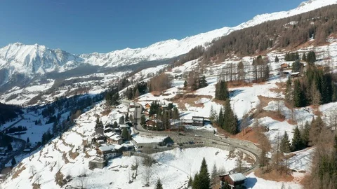 Aerial view of cabins located on a mountain slope in the Alps Stock Footage 128986427