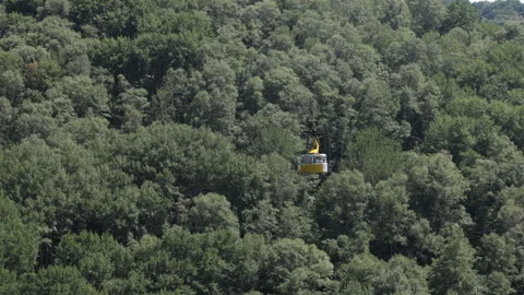 Aerial view of cable car in the mountains with forest Stock Footage 301300086