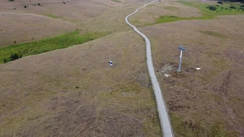 Aerial View of Cable Car Over a Mountainous Pathway Stock Footage 289221736