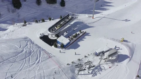 Aerial view of cable car stations with skiers in alpine ski resort at bright day Stock Footage 169210403