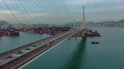 Aerial View of Cable-Stayed Bridge Spanning Harbor with Cargo Ships and City Video stock 310990157