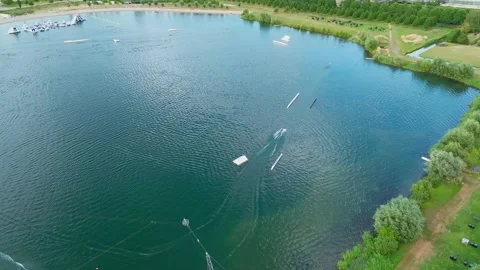 Aerial view of cable water ski park with obstacles and ramps Stock Footage 345112696