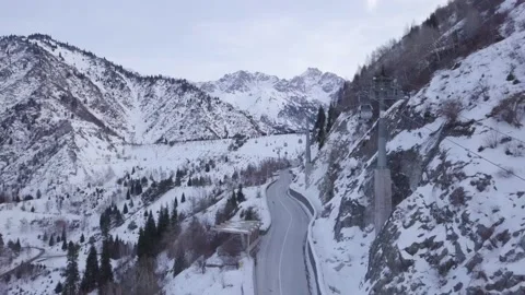 Aerial view Cable way above serpentine of paved road on hillside of the mountain Stock Footage 144045344