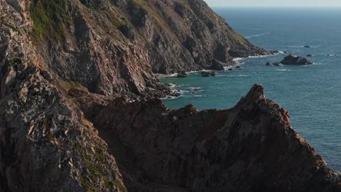 Aerial view of a Cabo da Roca lighthouse surrounded with rugged coastline. Stock Footage 315692147