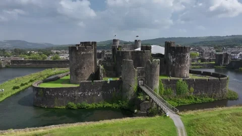 Aerial view of Caerphilly Castle and surrounding landscape on a bright day, Stock Footage 287729689