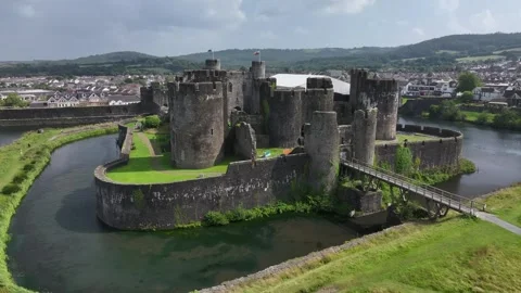 Aerial view of Caerphilly Castle and surrounding landscape on a bright day, Stock Footage 287730045