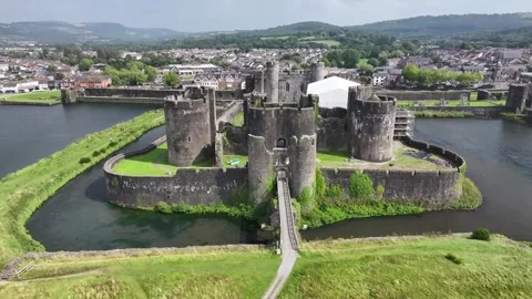 Aerial view of Caerphilly Castle and surrounding landscape on a bright day, Stock Footage 287730439