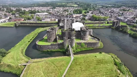 Aerial view of Caerphilly Castle and surrounding landscape on a bright day, Stock Footage 287730747