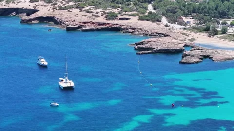 Aerial view of Cala Comte beach with yachts in Ibiza, Spain Stock Footage 317122523