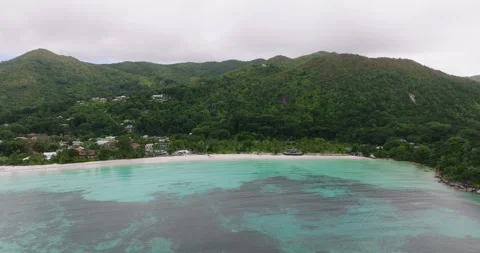 Aerial view of a calm bay surrounded by lush mountains. Praslin, Seychelles. Stock Footage 310816757