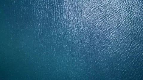 Aerial view of calm, deep blue ocean water with gentle ripples and natural Video stock 285509935